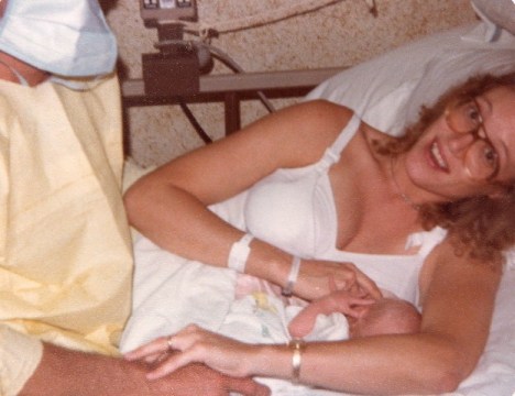 1979 Father wearing gown and mask to attend feeding